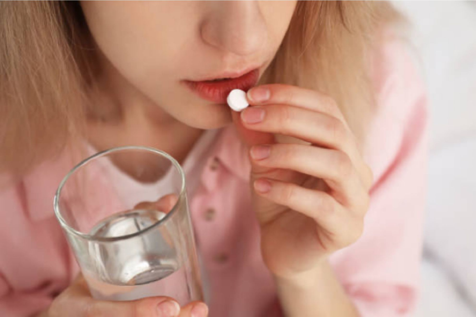 woman taking a pill